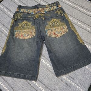 This is a pair of vintage Y2K Crown Holder embroidered denim jeans.